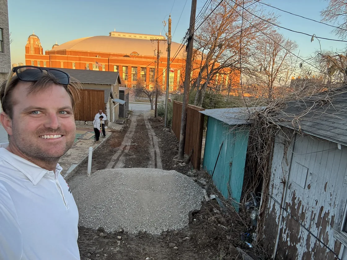 Selfie on a job site with a Fort Worth arena behind