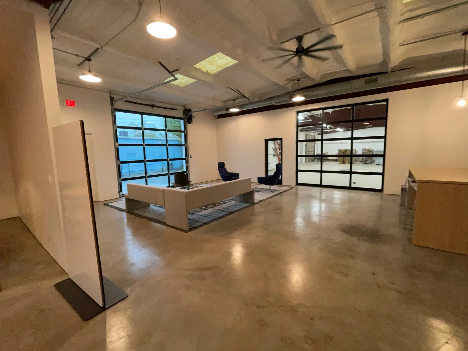 Finished office space with a polished concrete floor and glass roll up doors, commercial tenant finish out