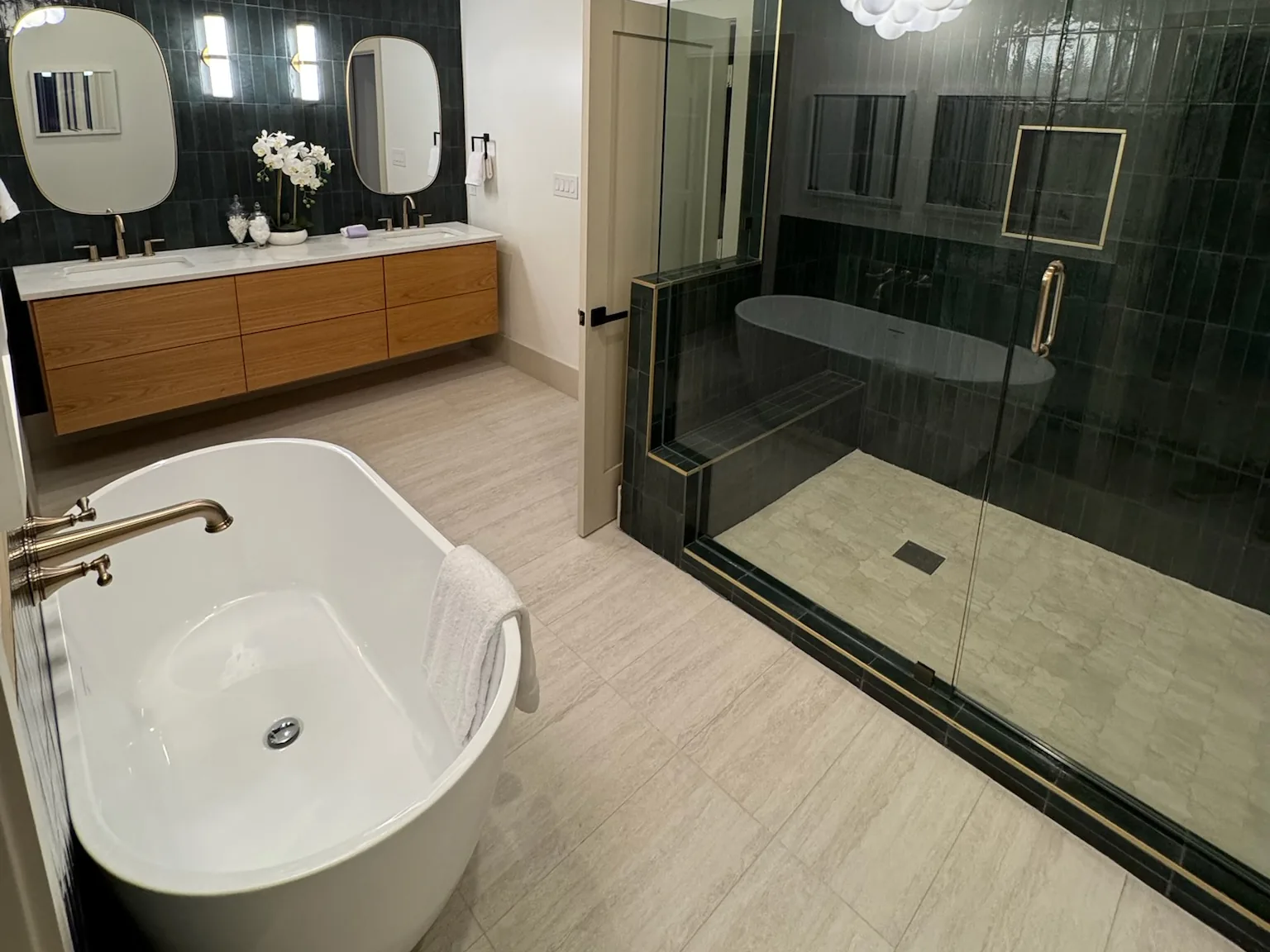 New bathroom with a freestanding tub, a double vanity and a glass shower, custom home construction