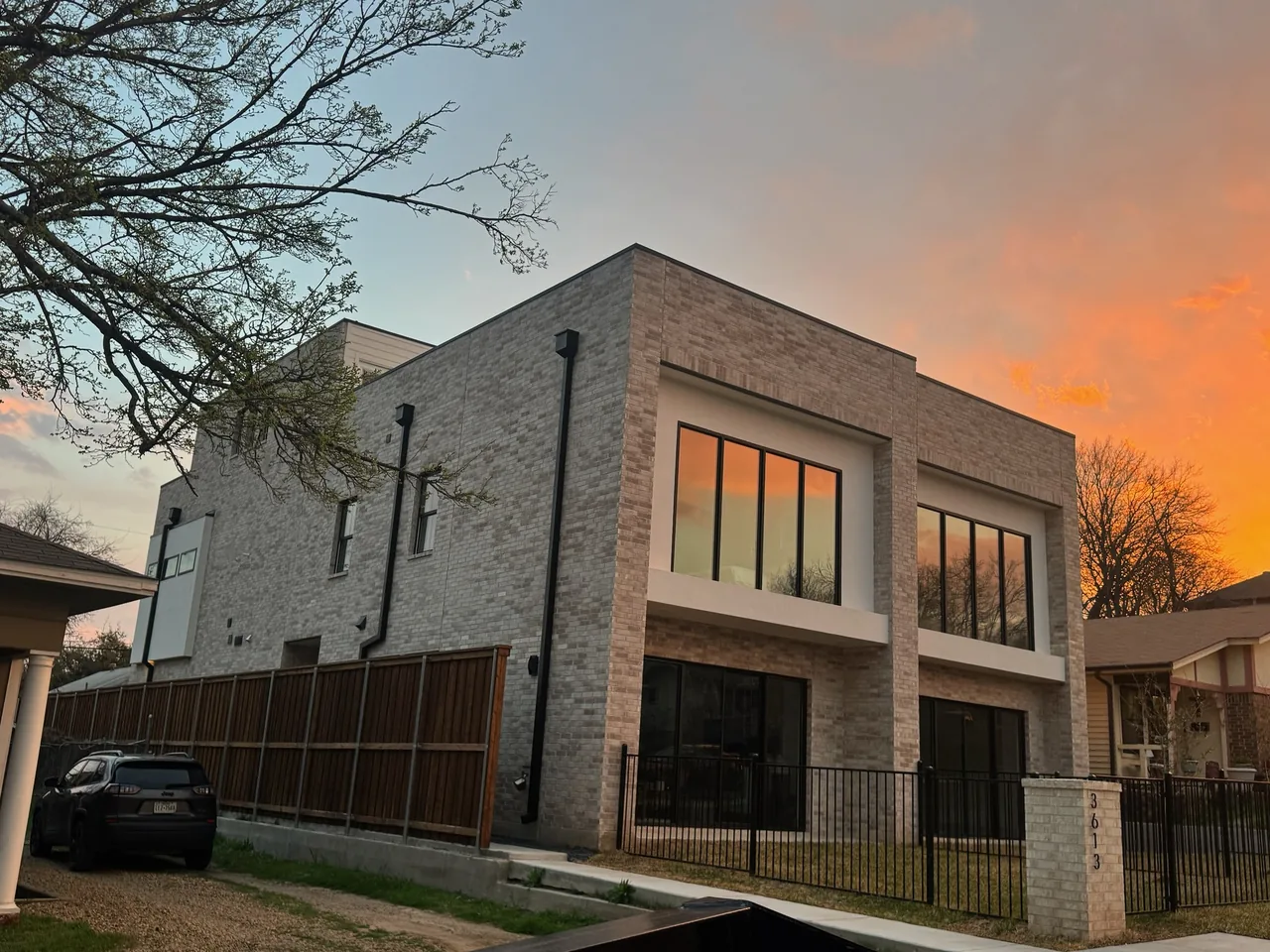 New two story brick and stucco home at sunset, custom home construction