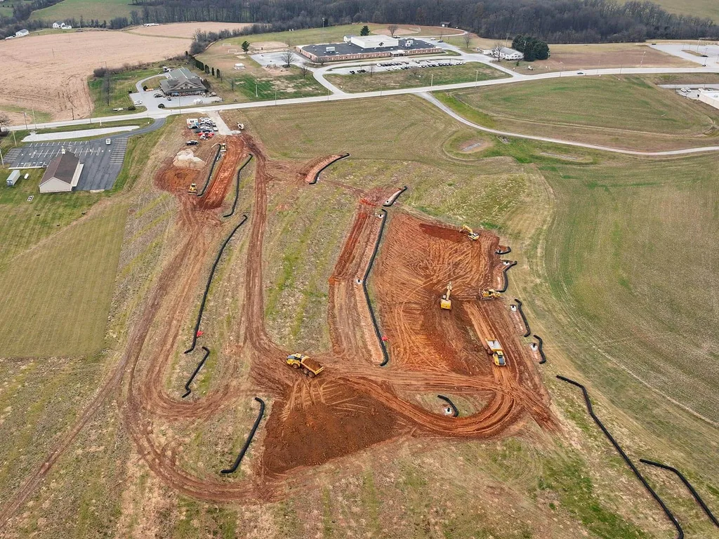 Aerial view of excavators grading pads and cuts on a large site, data center site work