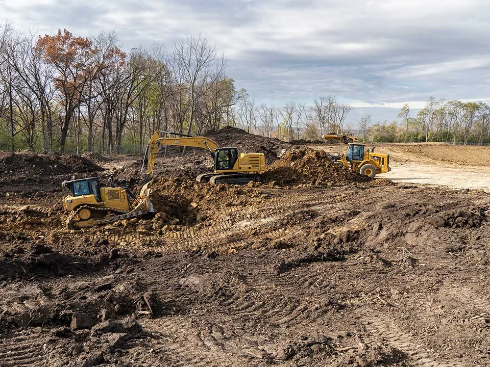 Dozer, excavator and wheel loader rough grading a large cleared tract, data center site work