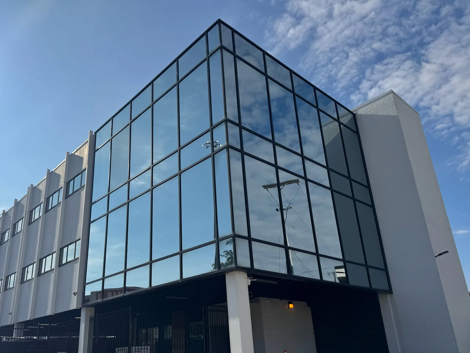 Renovated office building with a new glass curtain wall corner, commercial construction