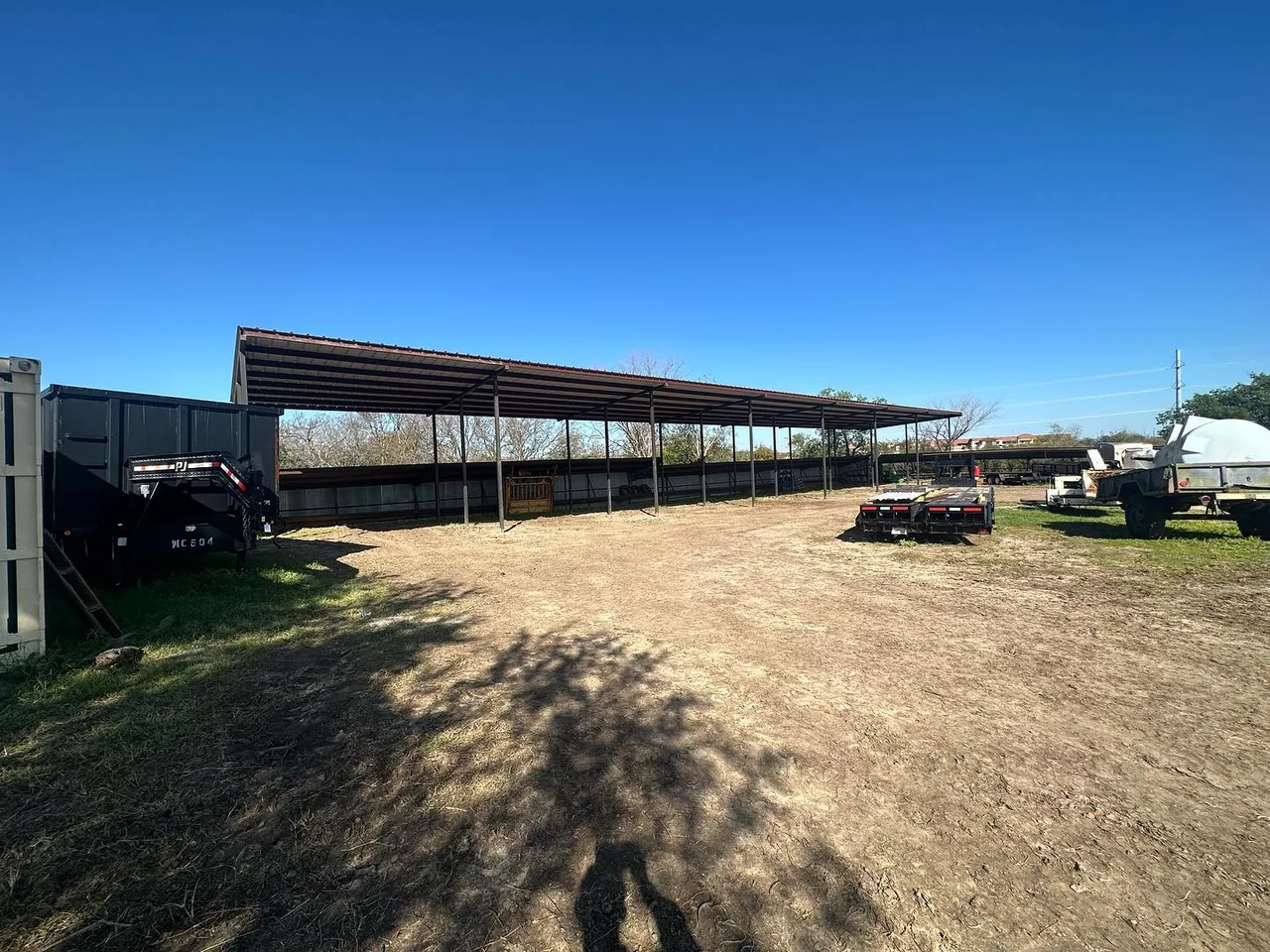Graded ground around a new steel carport, land grading