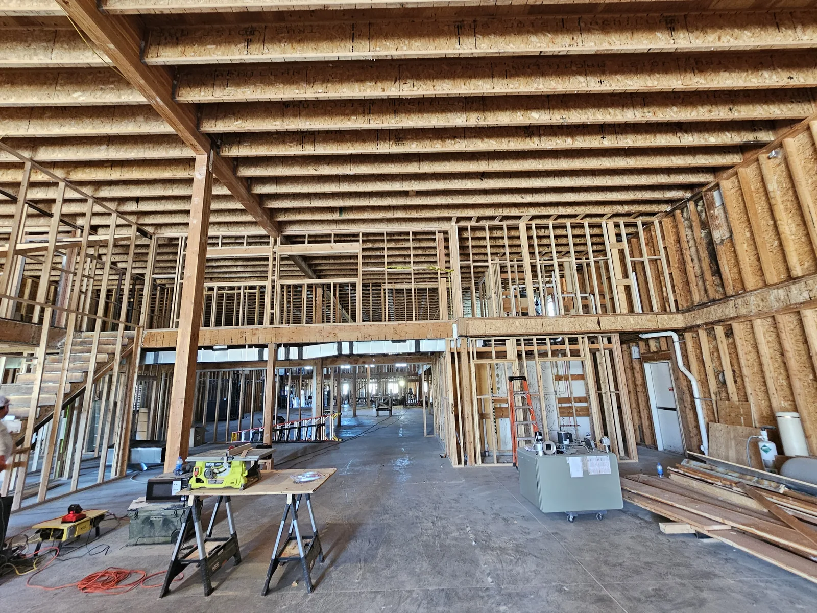 New wood framing for interior walls and a mezzanine inside a building shell, commercial construction