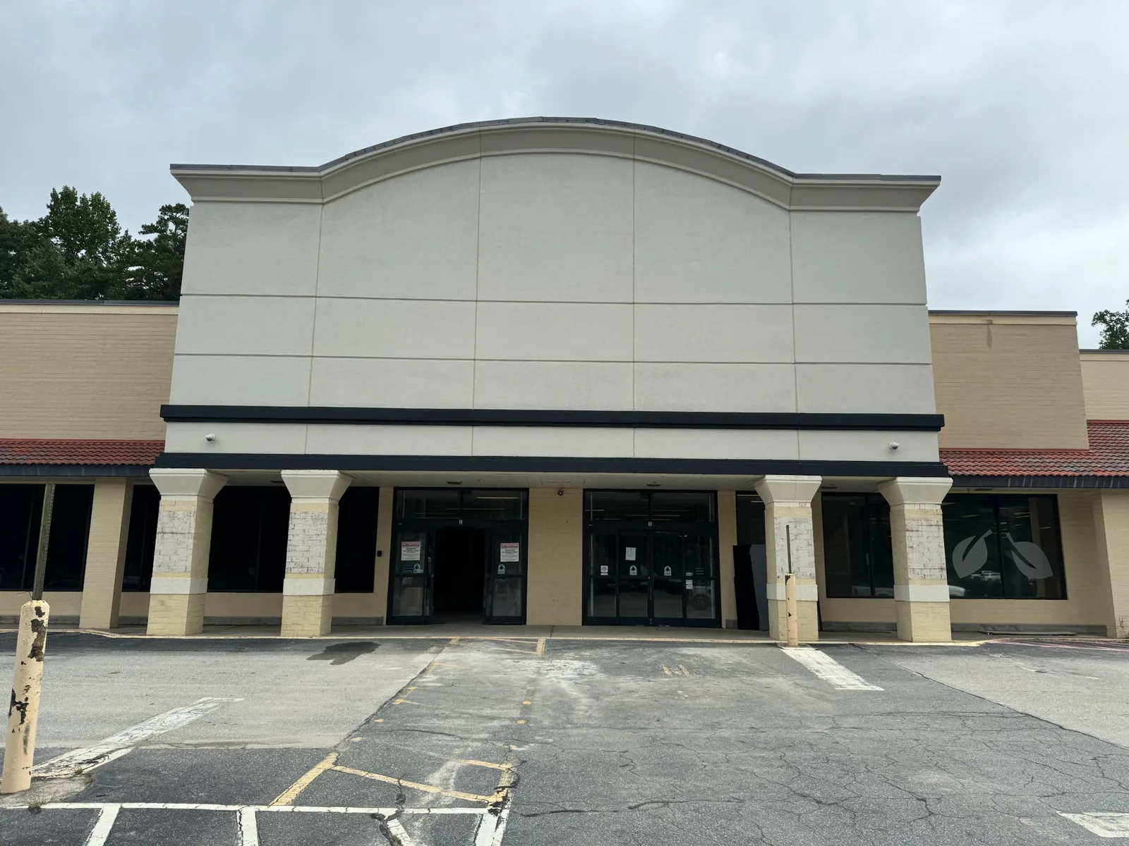 Store front with a new stucco facade and the arch window filled in, commercial construction