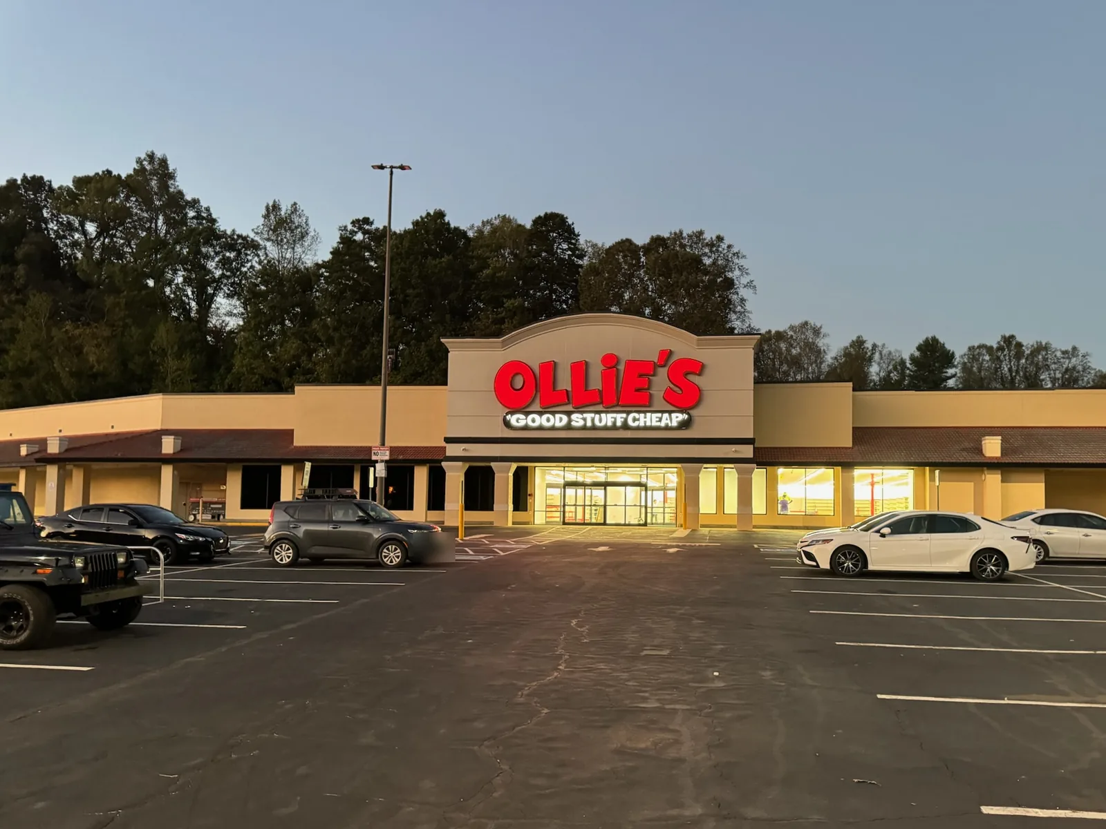 Finished Ollie's store with its lit sign at dusk, commercial construction