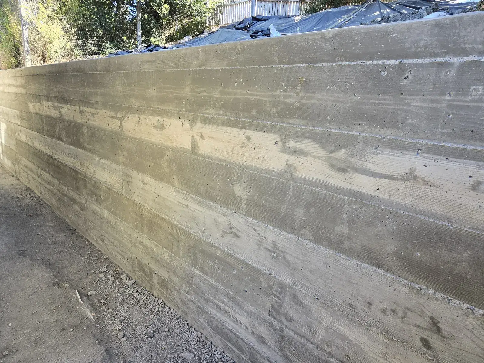 Finished board formed concrete retaining wall holding a slope, retaining walls